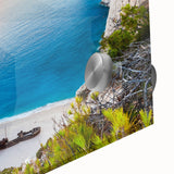 Close-up of a vibrant acrylic glass wall art piece featuring a serene beach landscape with turquoise waters, soft white sand, and a clear blue sky, perfect for coastal decor.