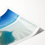 Rolled print of a serene beach landscape with soft pastel hues, showcasing gentle waves and a tranquil sky, designed for wall art decor, elegantly packaged.