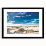 Framed wall art featuring a serene beach landscape with vibrant colors, black matting, and a sleek black frame, perfect for coastal-themed decor.