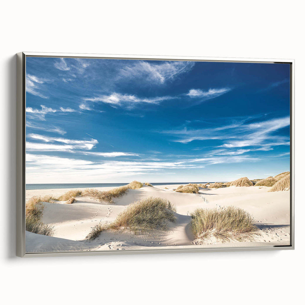 Framed canvas wall art showcasing a serene beach landscape with silver accents, perfect for home decor. The artwork captures tranquil ocean waves and a clear sky, enhancing any living space with a touch of nature's beauty.