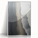 Framed wall art depicting a tranquil beach landscape with soft waves and a blue sky, showcasing a white frame that enhances the serene coastal theme. Perfect for home decor.