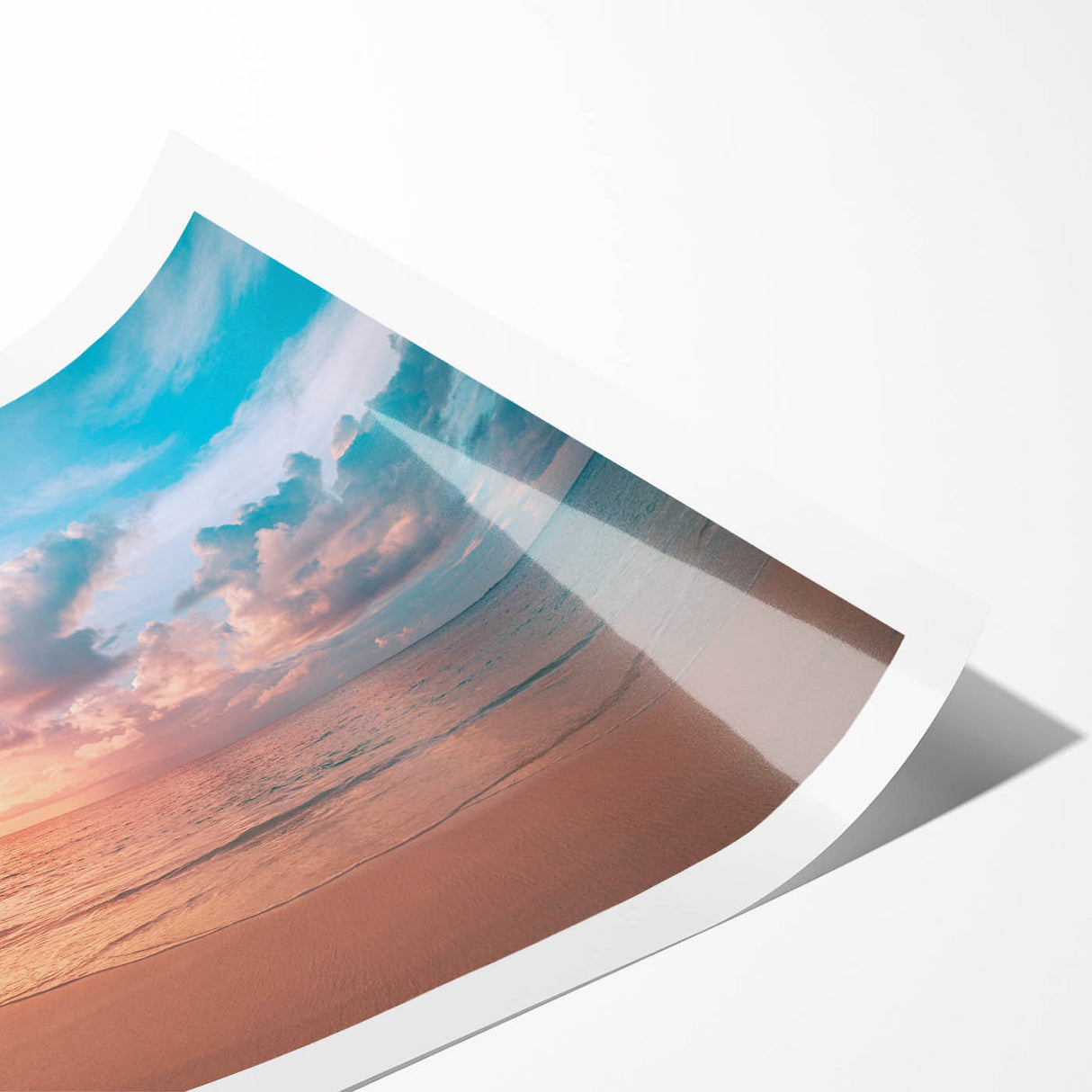 Vibrant rolled print of a beach landscape featuring soft waves and a serene sunset, ideal for coastal home decor, packaged securely in a protective tube.