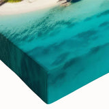 Close-up of a stretched canvas wall art piece showcasing a vibrant beach landscape with soft waves and a colorful sunset, perfect for coastal decor accents.