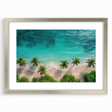 Framed wall art showcasing a serene beach landscape in calming hues of blue and beige, featuring a silver frame with matting, perfect for home decor.