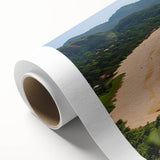 Colorful rolled canvas artwork depicting a serene beach landscape with vibrant skies and gentle waves, ideal for enhancing home decor in coastal themes.