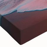 Close-up of a vibrant stretched canvas art piece showcasing a serene beach landscape, featuring soft waves, golden sands, and lush palm trees, perfect for coastal decor.