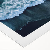 Vibrant rolled canvas artwork depicting a serene beach landscape at sunset, showcasing warm hues of orange, pink, and blue, perfect for coastal home decor.