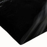 Close-up of a stretched canvas wall art piece depicting a serene beach landscape with vibrant colors, perfect for home decor. The design showcases calming ocean waves and soft sandy shores, ideal for creating a tranquil atmosphere in any room.