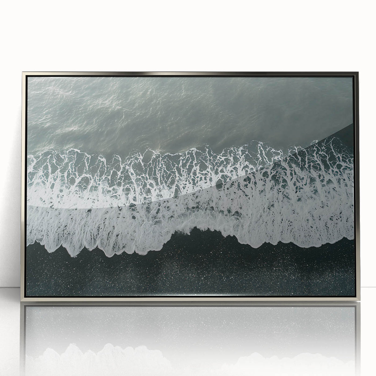 Framed acrylic wall art showcasing a serene beach landscape, featuring vibrant blues and sandy tones, set in a sleek silver frame for modern decor.