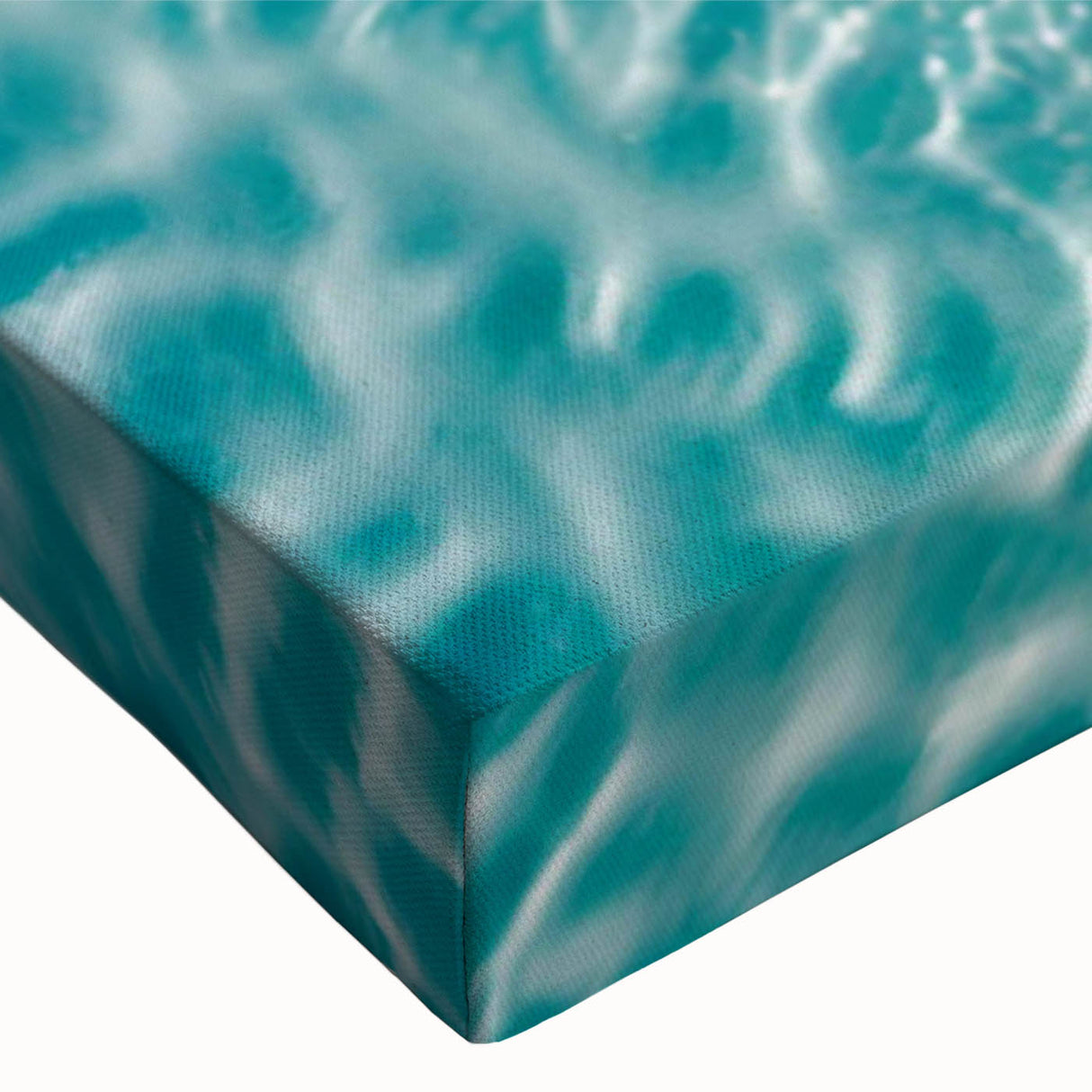 Close-up of a vibrant stretched canvas wall art piece depicting a serene beach landscape, featuring rich blues and sandy tones, perfect for coastal decor enthusiasts.