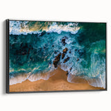 Framed canvas wall art showcasing a serene beach landscape design, featuring vibrant blue skies and golden sand, with a sleek black frame enhancing its elegance.