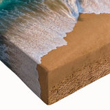 Close-up of a vibrant stretched canvas depicting a serene beach landscape with soft waves and a colorful sunset, ideal for home decor and relaxation ambiance.