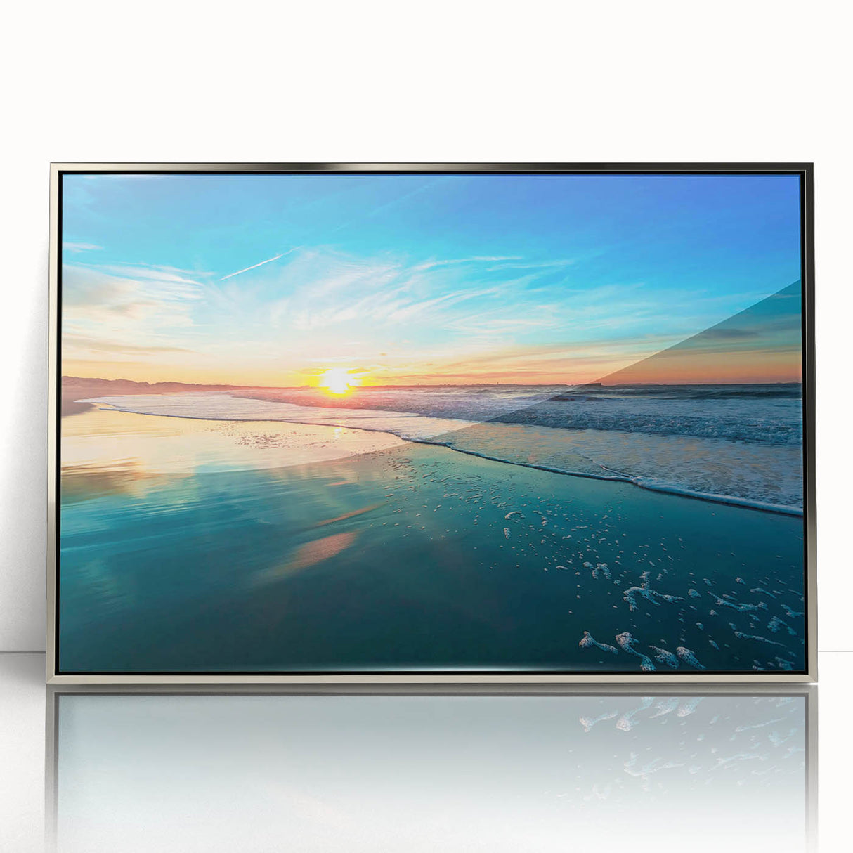 Framed wall art featuring a serene beach landscape with soft waves and a vibrant sunset, highlighted by a sleek silver frame, perfect for home decor.