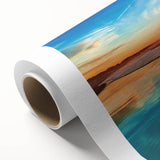 Vibrant rolled canvas wall art showcasing a serene beach landscape at sunset, featuring warm hues of orange and blue, perfect for home decor or relaxation.