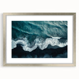 Framed landscape wall art depicting a serene beach scene, featuring gentle waves and a pastel sky, elegantly presented in a silver frame with matting. Perfect for enhancing coastal decor themes.