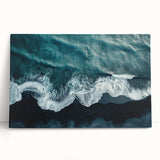 Stretched canvas wall art showcasing a vibrant beach landscape design, featuring vivid blues and sandy tones, leaning against a neutral wall, perfect for home decor.