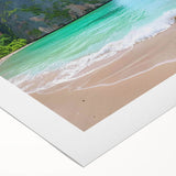 Vibrant rolled canvas wall art featuring a serene beach landscape, showcasing soft turquoise waters and golden sand under a clear blue sky, ideal for home decor.