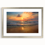 Framed wall art featuring a serene beach landscape with soft waves and golden sand, elegantly presented with a silver mat and frame, ideal for home decor.