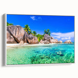 Framed canvas wall art depicting a serene beach landscape, featuring soft blue skies and gentle waves, elegantly displayed with a white frame, ideal for home decor.