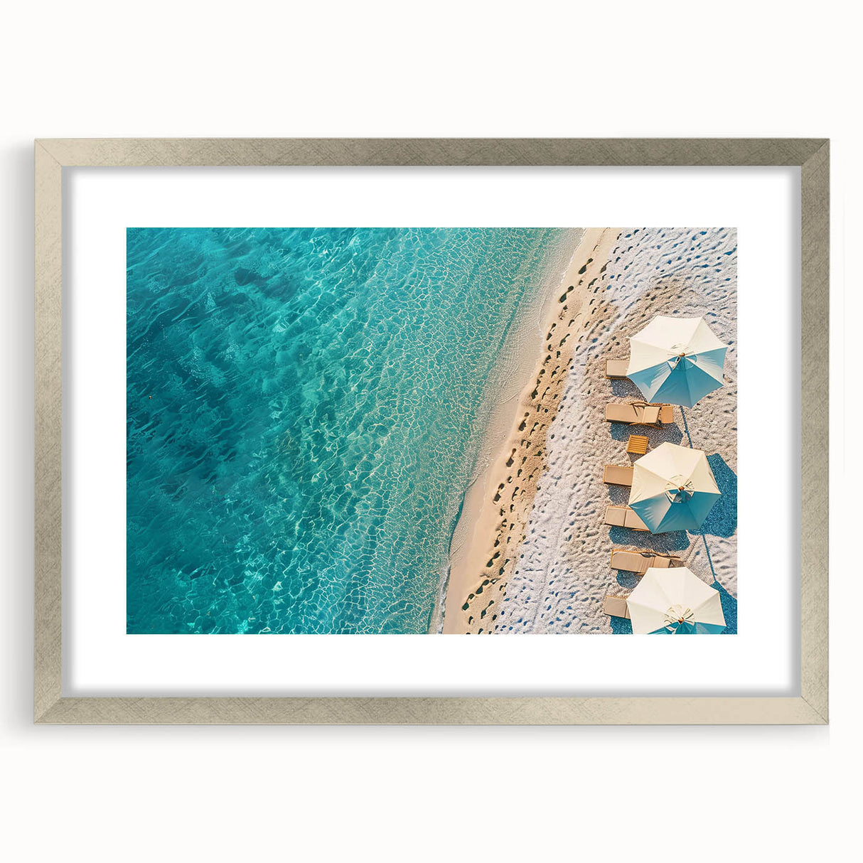 Framed silver wall art featuring a serene beach landscape design, complete with a mat for enhanced presentation. Ideal for enhancing home decor with a coastal aesthetic.
