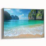 Framed canvas wall art showcasing a serene beach landscape, featuring soft blue and sandy beige tones with a silver frame, ideal for coastal-themed decor.