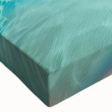 Close-up of a stretched canvas wall art print showcasing a vibrant beach landscape design, featuring vivid blue skies and golden sands, perfect for home decor.