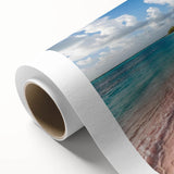 Vibrant rolled canvas artwork showcasing a serene beach landscape, featuring soft waves and a colorful sunset, ideal for home décor. Packaged securely for shipping.