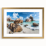 Framed wall art featuring a serene beach landscape with golden accents, ideal for home decor. This piece showcases vibrant colors and a sophisticated matting.