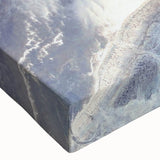 Close-up of a vibrant stretched canvas featuring a serene beach landscape design with soft waves and a sunset, ideal for enhancing home decor.