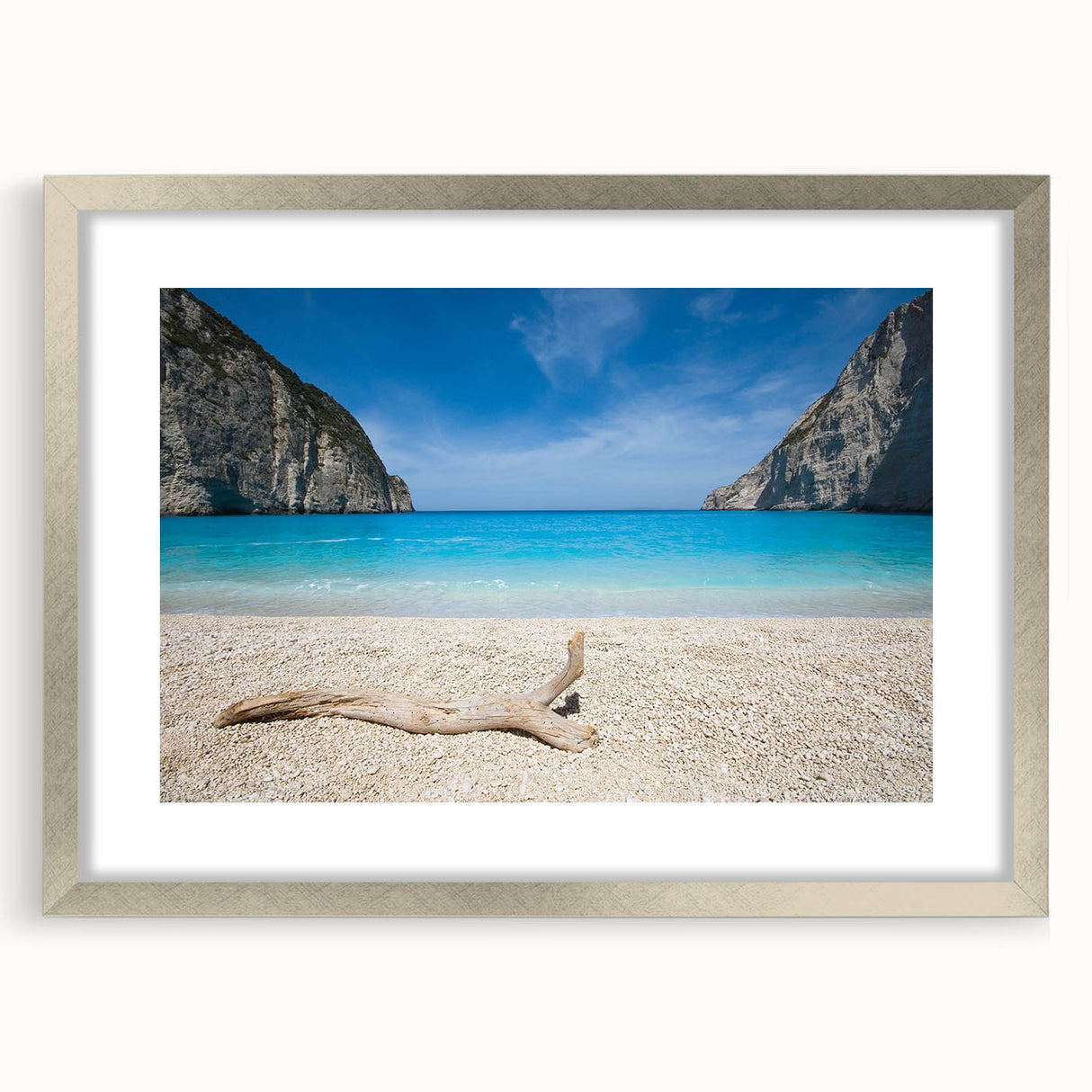 Framed wall art featuring a serene beach landscape with soft waves and a sunset backdrop, elegantly presented in a silver frame with a mat, perfect for home decor.