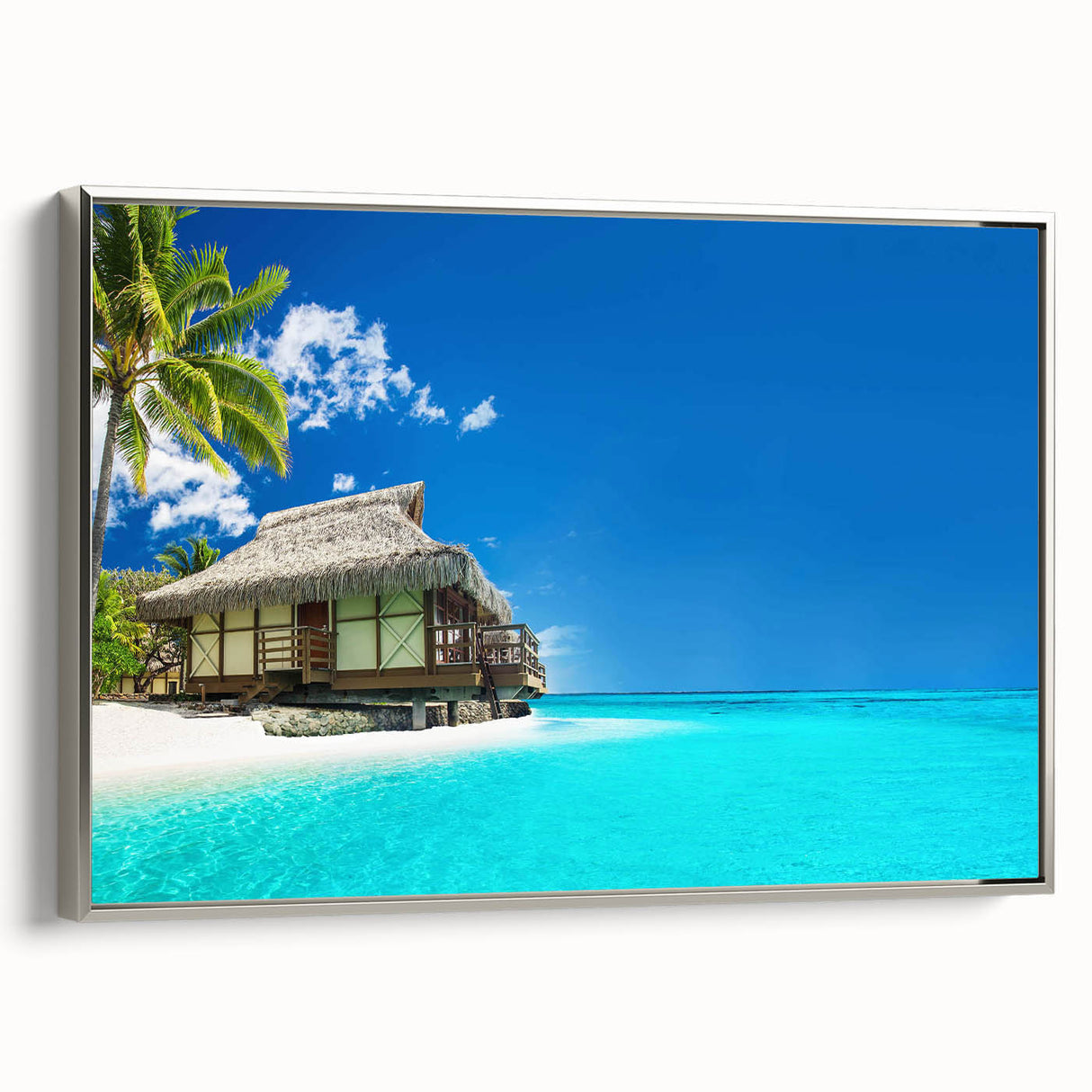 Framed wall art featuring a serene beach landscape with vibrant colors and silver accents, displayed in a stylish setting to enhance any home décor. This piece captures the essence of coastal tranquility, making it perfect for beach lovers and interior design enthusiasts.