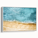 Framed canvas wall art featuring a serene beach landscape with vibrant blue skies and soft white sand, ideal for coastal decor, displayed in a stylish white frame.