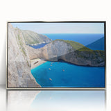 Framed wall art featuring a serene beach landscape with soft waves and a sunset in silver-accented frame, perfect for coastal-themed decor.