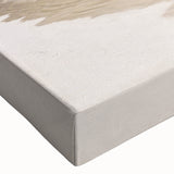 Close-up of a stretched canvas wall art piece depicting a vibrant beach landscape, showcasing rich blues and sandy tones, perfect for coastal decor enthusiasts.