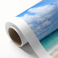 Vibrant rolled canvas artwork depicting a serene beach landscape with vivid colors, perfect for home decor, presented in a protective cardboard tube.