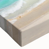 Close-up of a stretched canvas wall art piece showcasing a vibrant beach landscape design, featuring soothing blue and sandy tones, perfect for coastal décor.