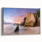 Framed canvas wall art showcasing a serene beach landscape with vibrant blue skies and gentle waves, elegantly displayed with a silver frame to enhance decor.