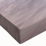 Close-up of a vibrant stretched canvas wall art piece depicting a serene beach landscape, featuring soft blues and sandy tones, perfect for coastal decor enthusiasts.