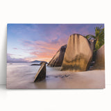 Stretched canvas artwork showcasing a serene beach landscape with vibrant colors, perfect for home decor, leaning against a neutral wall for display.