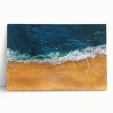 Stretched canvas wall art showcasing a serene beach landscape with soft pastel colors, leaning against a neutral backdrop, perfect for coastal-themed decor.