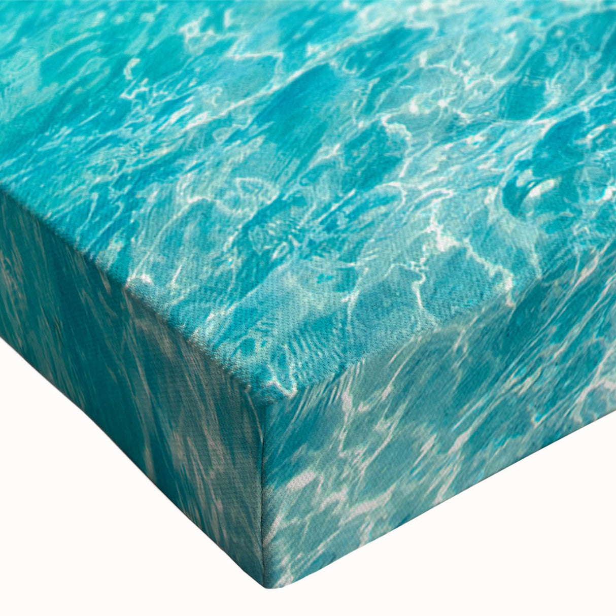 Close-up view of a stretched canvas wall art piece showcasing a vibrant beach landscape design, featuring vivid blues and sandy tones, perfect for coastal home decor.