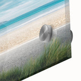 Close-up of a vibrant acrylic glass wall art piece showcasing a serene beach landscape with soft waves and a colorful sunset, ideal for modern home decor.