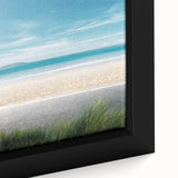 Close-up of a framed canvas wall art piece showcasing a vibrant beach landscape, featuring rich blues and sandy tones, perfect for coastal-themed decor. The artwork captures the essence of tranquility and natural beauty, ideal for enhancing living spaces.