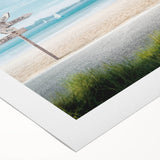 Vibrant rolled canvas wall art showcasing a serene beach landscape with golden sands and azure waves, ideal for bringing a coastal vibe to any room.