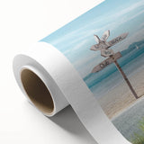 Rolled canvas artwork showcasing a serene beach landscape with soft pastel colors, ideal for home decor. Comes in a protective cardboard tube for easy transport.