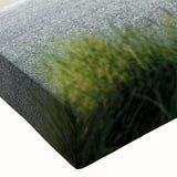 Close-up of a stretched canvas wall art piece showcasing a vibrant beach landscape design, featuring vivid blues and sandy tones, perfect for coastal decor.