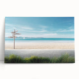 Stretched canvas wall art showcasing a serene beach landscape with vibrant colors and soft waves, perfect for coastal-themed home decor. The artwork leans against a neutral wall, highlighting its tranquil ambiance and inviting summer vibes.