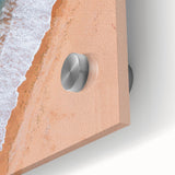 Close-up of a vibrant acrylic glass wall art piece showcasing a serene beach landscape, featuring soft blue waves, golden sand, and lush greenery, perfect for home decor.