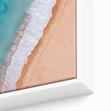Close-up of a framed canvas wall art piece showcasing a vibrant beach landscape design, featuring soft waves, golden sands, and a serene sunset, perfect for coastal decor enthusiasts.