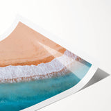 Vibrant rolled print of a serene beach landscape featuring golden sands and turquoise waves, perfect for adding a coastal touch to home decor.